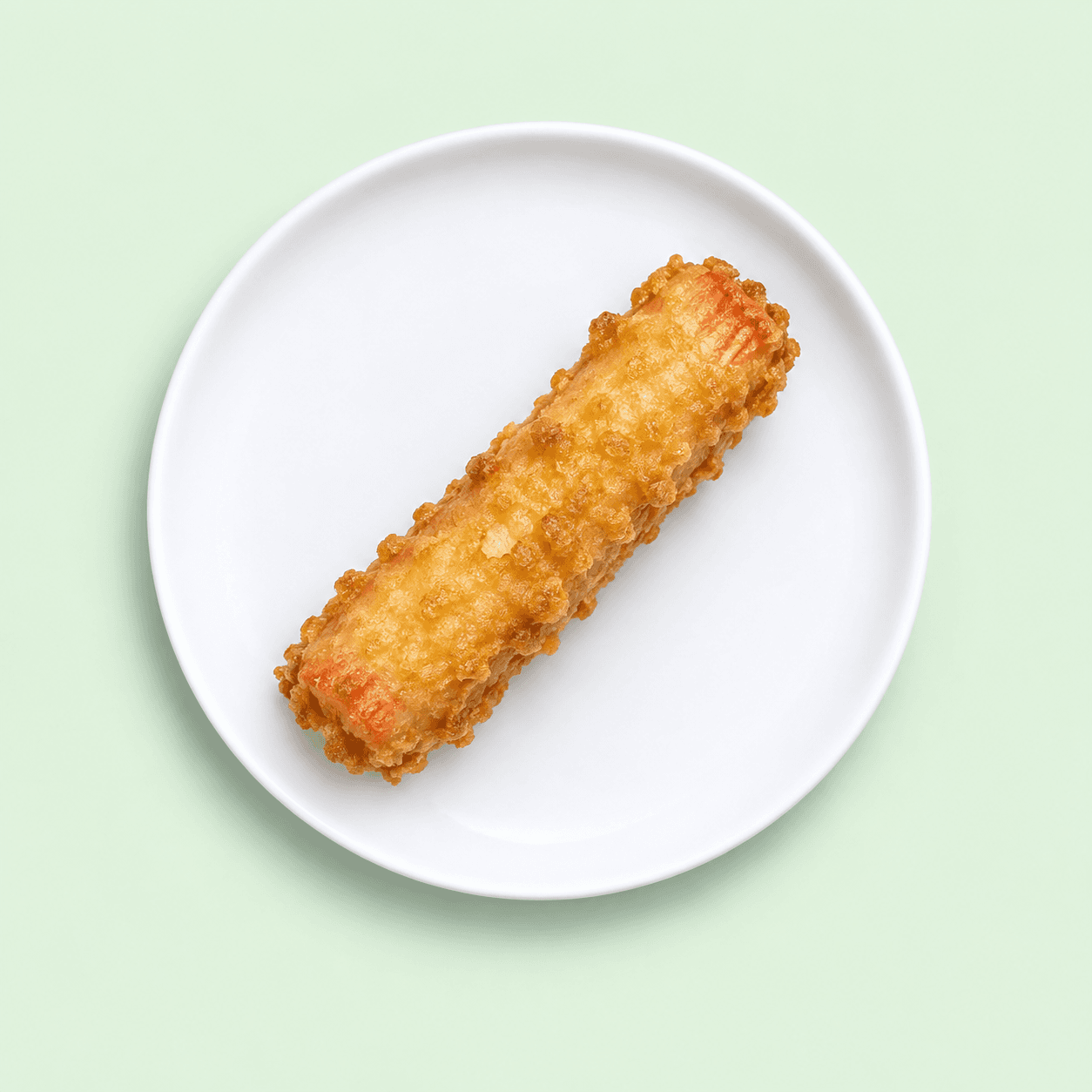 Golden battered crab stick on a white plate