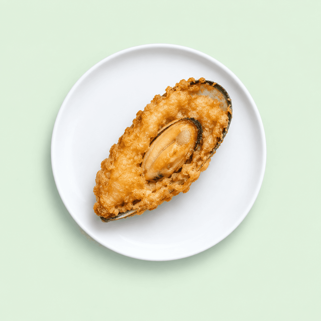 Large battered mussel on a white plate