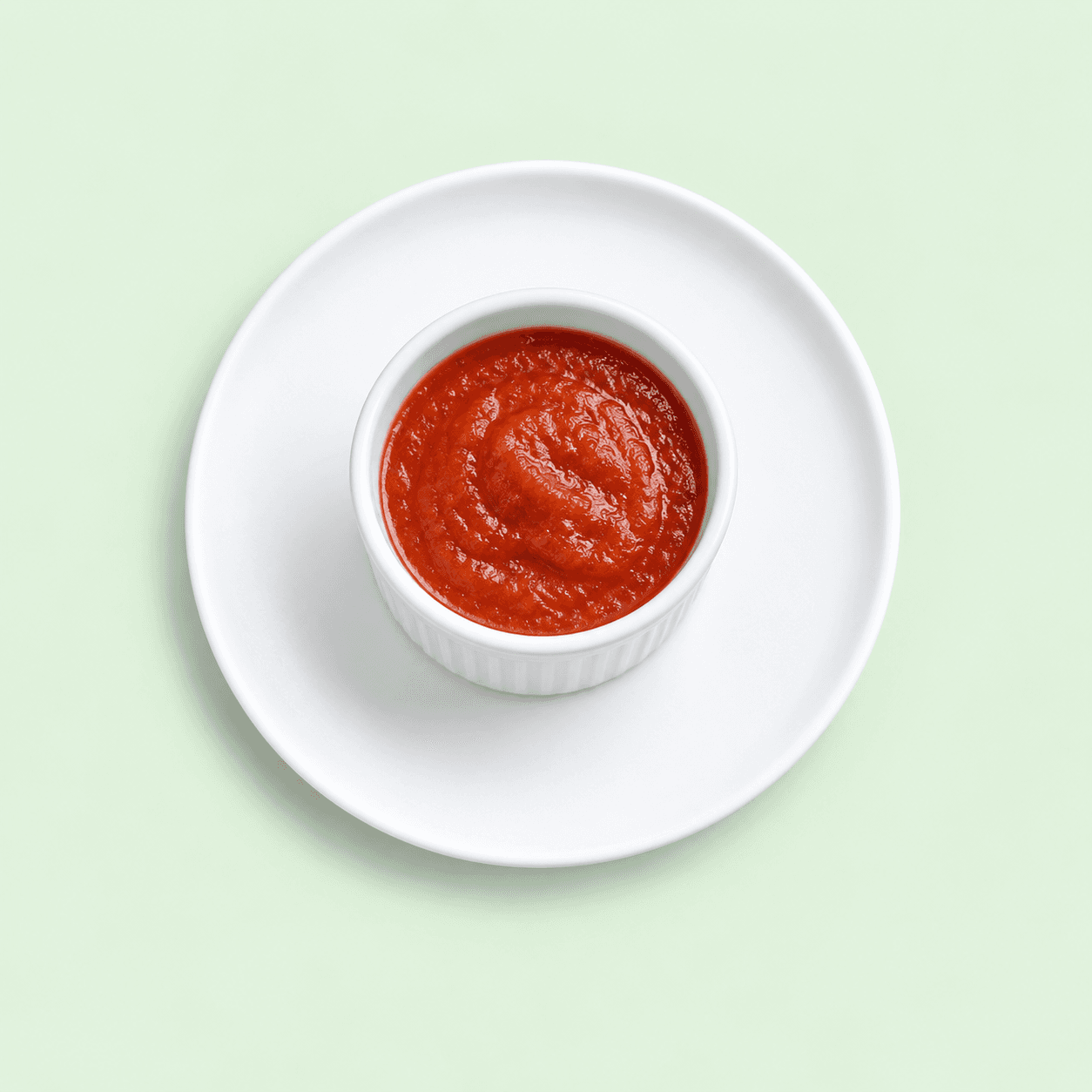 Tomato sauce in a small white ramekin
